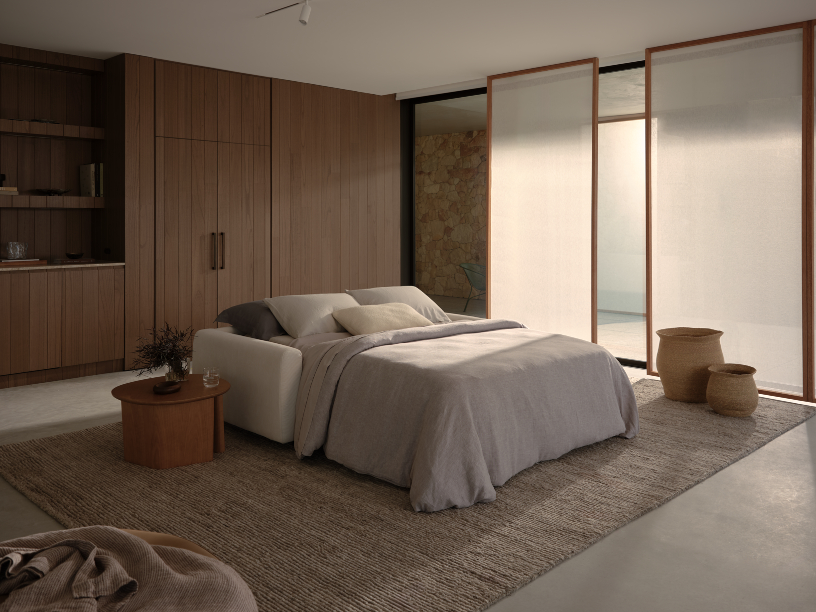 A modern open sofa bed with neutral-toned bedding.