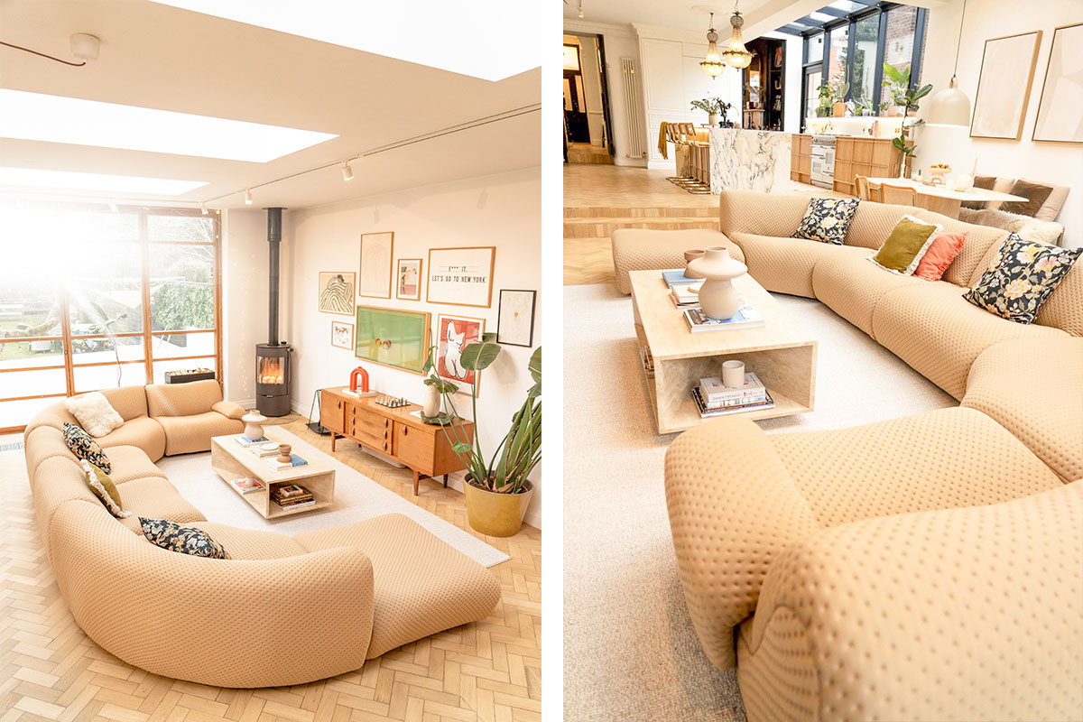 Spacious sunlit living room featuring a curved tan sofa, marble coffee table, and a neutral-toned rug, styled with warm textures and soft furnishings.